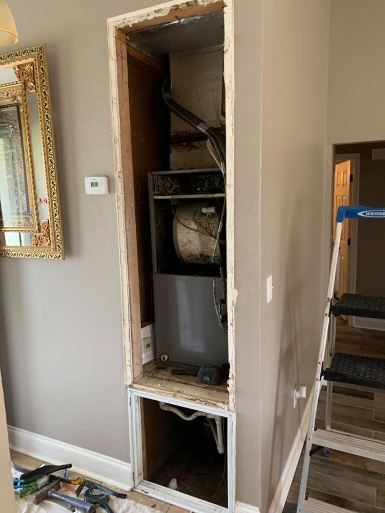 An indoor air handler or furnace unit being serviced or installed in a utility closet by Get RiTe A/C & Heating in Madisonville, LA.