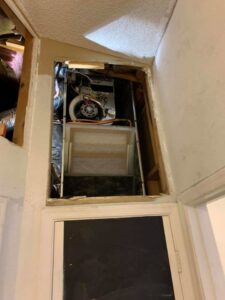 An indoor air handler or furnace unit visible through an access panel, serviced by Arizaz Heating & Cooling in Chandler, AZ.