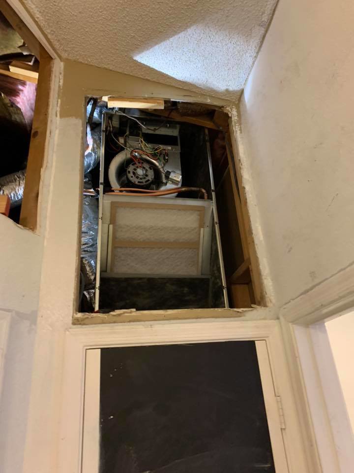 An indoor air handler or furnace unit visible through an access panel, serviced by Arizaz Heating & Cooling in Chandler, AZ.