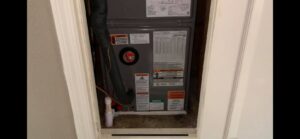 An indoor air handler or furnace unit neatly installed in a utility closet by Get RiTe A/C & Heating in Madisonville, LA.