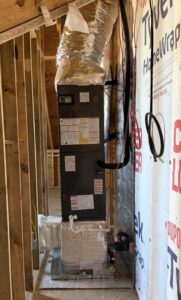 An indoor air handler unit installed within the framing of a new build home by Triune Air in Smithville, TN.