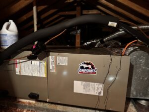An indoor air handler unit located in an attic, with the OnPoint Heating and Air logo, in Commerce City, CO.