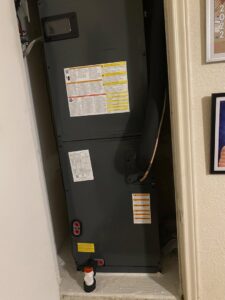 An indoor air handler unit installed in a utility closet by Manuel & Sons Service Co. in San Antonio, TX.