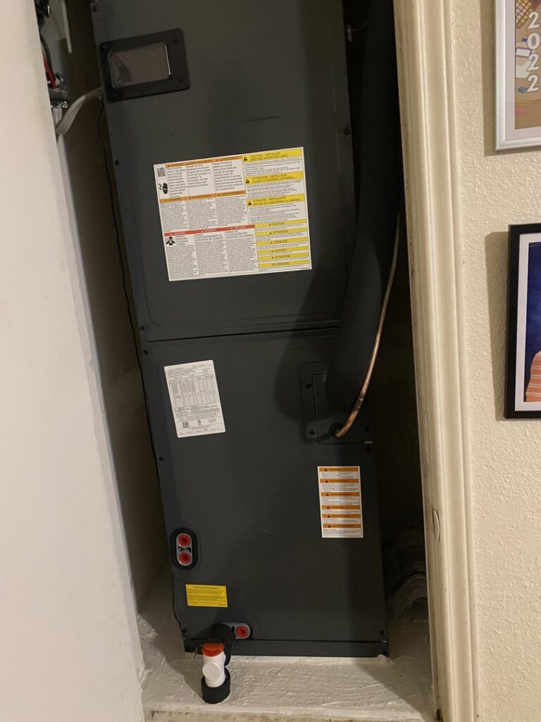 An indoor air handler unit installed in a utility closet by Manuel & Sons Service Co. in San Antonio, TX.