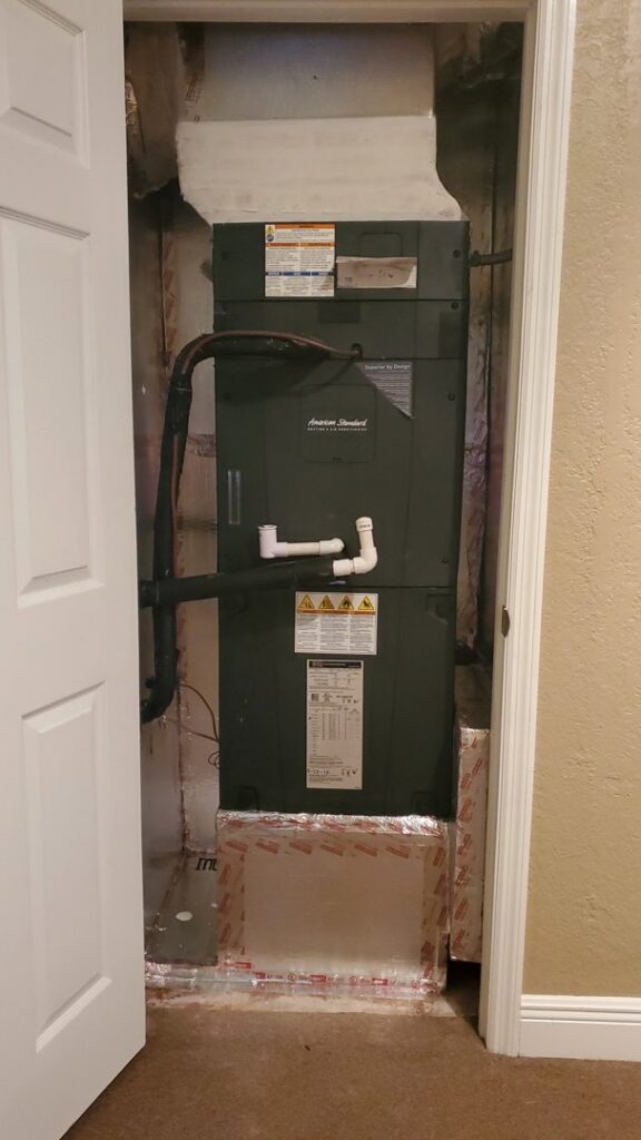 An indoor air handler unit installed in a utility closet by Uplifting Air, LLC in San Antonio, FL.