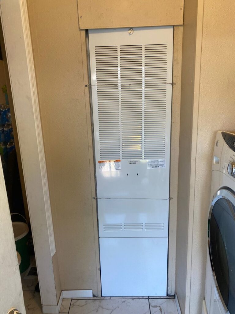 A tall indoor air handler unit installed in a utility closet by LUCAS Heating And Air LLC in Salt Lake City, UT.