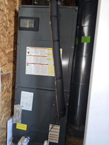 An indoor air handler unit with insulated lines and ductwork, installed by Temperature Comfort Heating and Cooling in Louisville, KY.