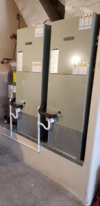 Two indoor air handler units installed in a utility room by Brisk Air Inc in Phoenix, AZ.