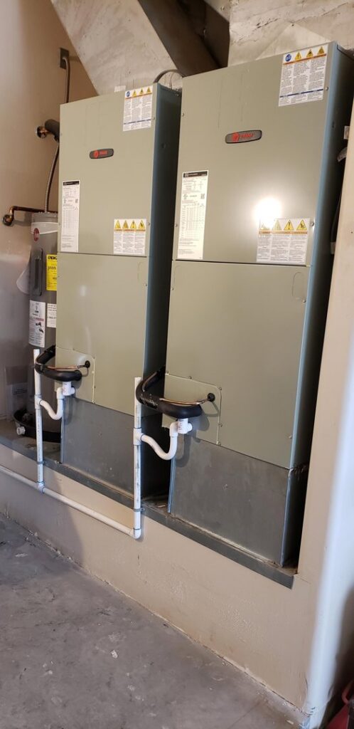 Two indoor air handler units installed in a utility room by Brisk Air Inc in Phoenix, AZ.