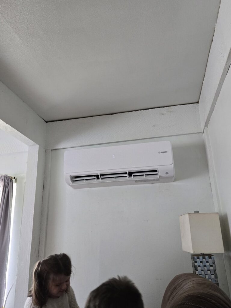 An indoor Bosch ductless mini-split unit installed on a wall in a room by Cummings Inc. in Puyallup, WA.