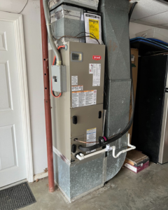 An indoor Bryant HVAC furnace unit with ductwork, installed by Madison HVAC/R, Inc in Richmond, KY.