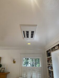 An indoor ceiling cassette HVAC unit installed in a room by Progressive Comfort Solutions in Seattle, WA.