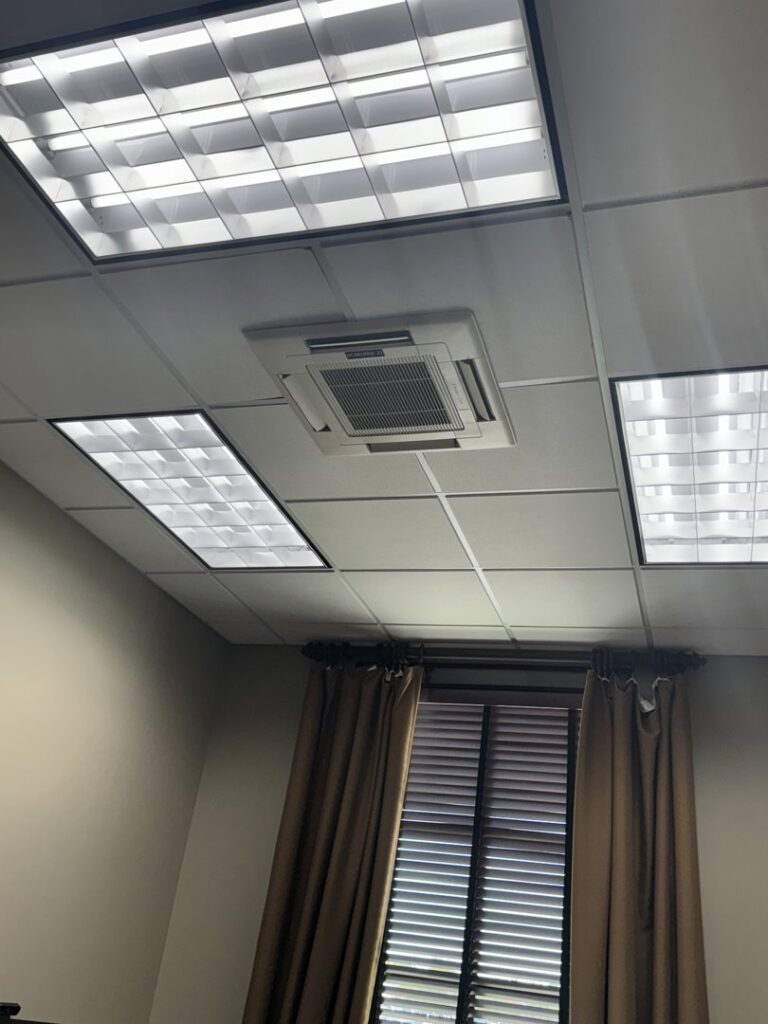 An indoor ceiling-mounted HVAC cassette unit installed in an office by Alpha HVAC LLC in Alexandria, LA.