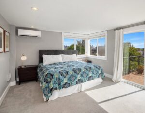 An indoor ductless mini-split unit installed in a bedroom by Progressive Comfort Solutions in Seattle, WA.