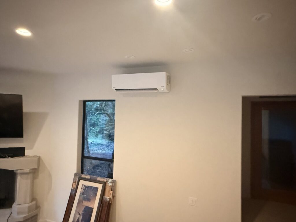 An indoor ductless mini-split unit installed on a wall in a living space by Cummings Inc. in Puyallup, WA.