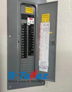 An indoor electrical breaker panel with the door open, showcasing the wiring and breakers by A-Tellez Electrical Services & Solutions L.L.C in Houston, TX.
