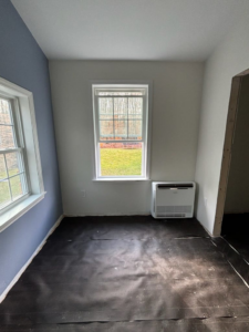 An indoor floor-mounted mini-split HVAC unit installed in a room by Sutton HVAC in Suncook, NH.
