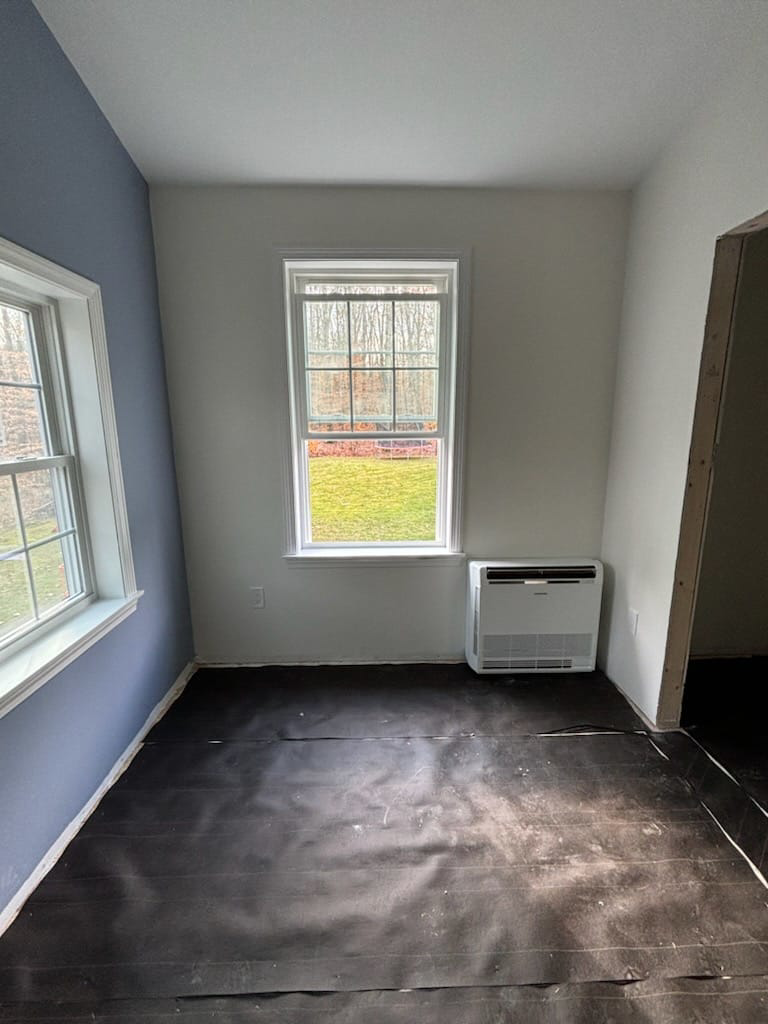 An indoor floor-mounted mini-split HVAC unit installed in a room by Sutton HVAC in Suncook, NH.