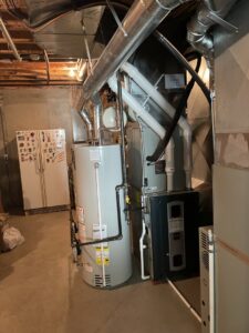 An indoor furnace, air handler, and water heater system installed by A-Team PHC in Olathe, KS.