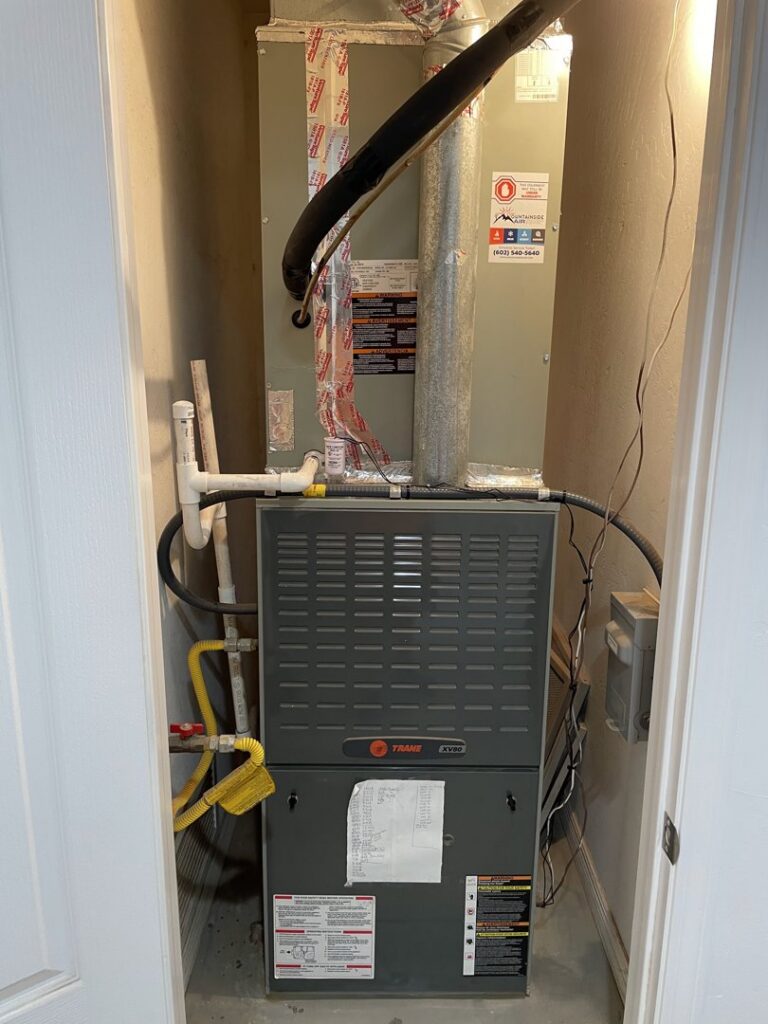 An indoor furnace and air handler unit installed in a utility closet by Mountainside Air in Phoenix, AZ.