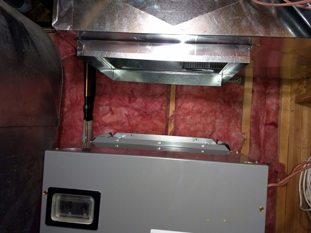 An indoor furnace or air handler unit with connected ductwork installed by Raytech Refrigeration, Heating & Cooling in Alamogordo, NM.