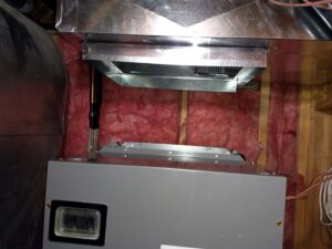 An indoor furnace or air handler unit with connected ductwork installed by Raytech Refrigeration, Heating & Cooling in Alamogordo, NM.