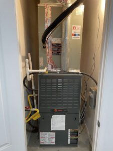 An indoor furnace and air handler unit installed in a utility closet by Mountainside Air in Phoenix, AZ.