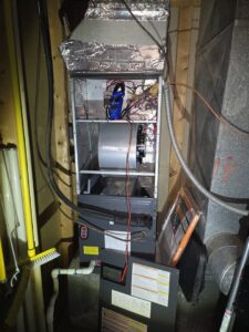 An indoor furnace or air handler being inspected by Booker Heating & Air in Richmond, VA.