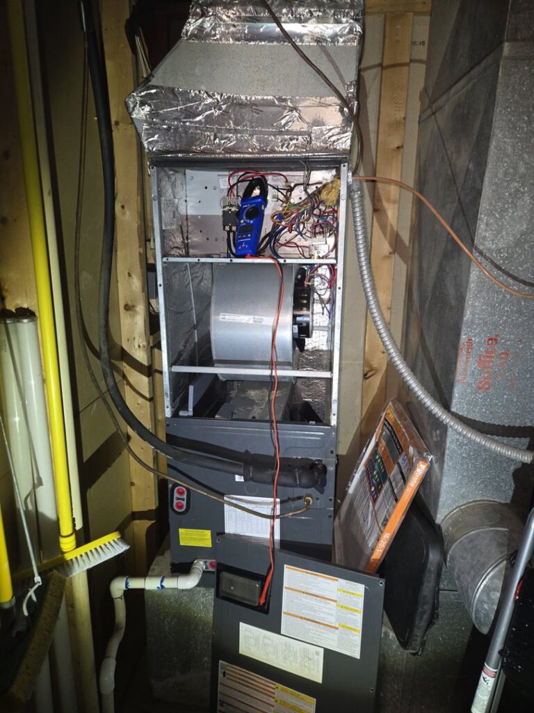 An indoor furnace or air handler being inspected by Booker Heating & Air in Richmond, VA.