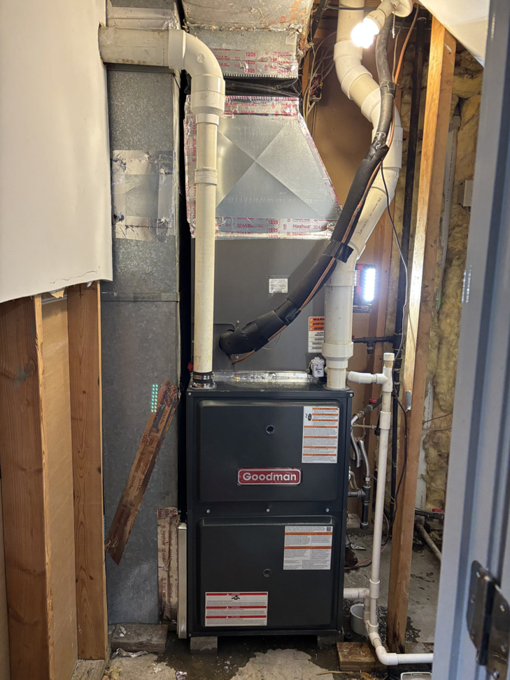 An indoor furnace and air handler unit with ductwork in a utility space, installed by AAA Heating & Air Conditioning Service Inc. in Lexington, KY.