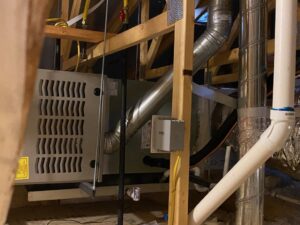 An indoor furnace and air handler unit with ductwork and wiring installed by Ace A/C & Heating in Henderson, NV.