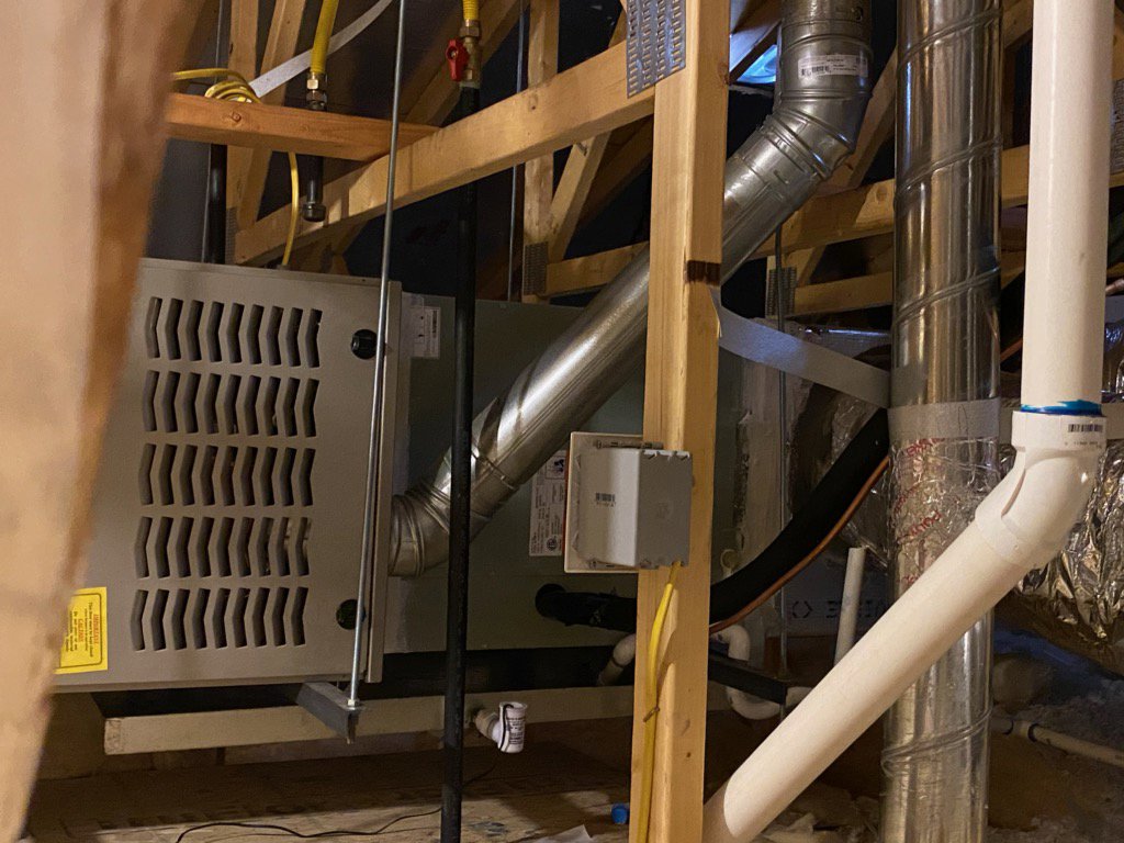 An indoor furnace and air handler unit with ductwork and wiring installed by Ace A/C & Heating in Henderson, NV.