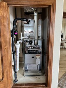 An indoor furnace and air handler unit installed in a closet by Aircon Heating and Cooling Inc in Las Cruces, NM