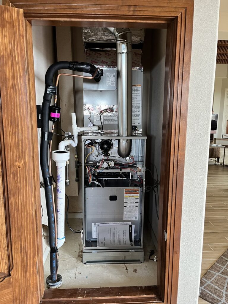 An indoor furnace and air handler unit installed in a closet by Aircon Heating and Cooling Inc in Las Cruces, NM