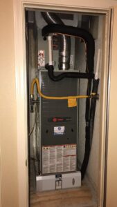 An indoor furnace and air handler unit professionally installed in a closet by Blue Sky Heating and Air in Austin, TX.
