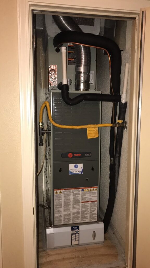 An indoor furnace and air handler unit professionally installed in a closet by Blue Sky Heating and Air in Austin, TX.
