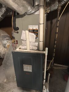 An indoor furnace and air handler unit with ductwork installed by Childers Air Plumbing & Electric in Beckley, WV.