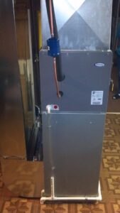 An indoor furnace and air handler unit installed by Huether Heating & Cooling Inc in Rochester, NY.