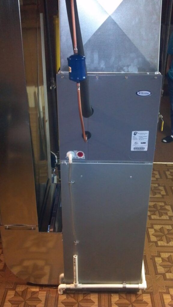 An indoor furnace and air handler unit installed by Huether Heating & Cooling Inc in Rochester, NY.