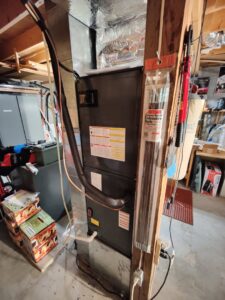 An indoor furnace and air handler unit installed in a utility space by Icy Hot HVAC in Spartanburg, SC