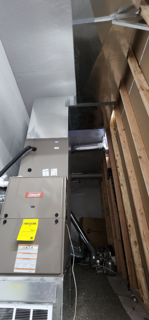 An indoor furnace and air handler unit with ductwork, installed by Jv Services inc. in Pinellas Park, FL.