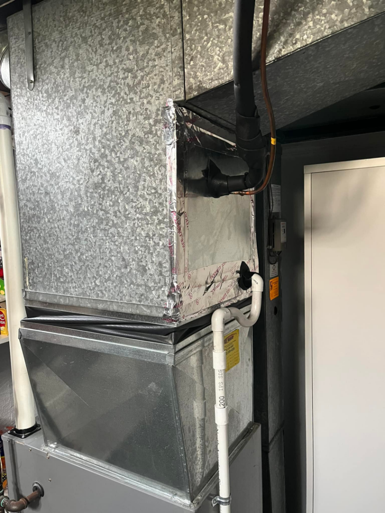 An indoor furnace and air handler unit with ductwork installed by Motown Mechanical Heating And Cooling in Westland, MI.