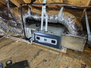 An indoor furnace and air handler unit with ductwork installed in an attic by OKIE Heating and Cooling in Tulsa, OK.