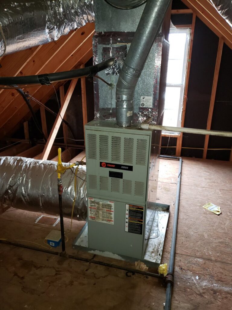 An indoor furnace and air handler unit with ductwork installed in an attic by Service Experts Memphis in Memphis, TN.