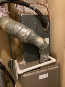 An indoor furnace or air handler unit with ductwork and condensate line, installed by TJ Mechanical Services LLC in Rock Hill, SC.