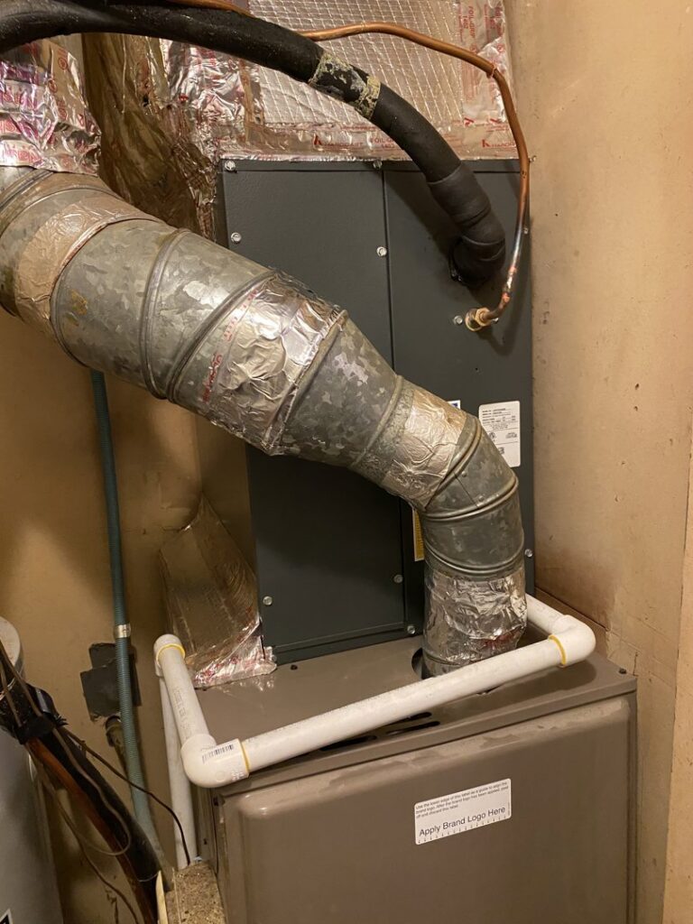 An indoor furnace or air handler unit with ductwork and condensate line, installed by TJ Mechanical Services LLC in Rock Hill, SC.