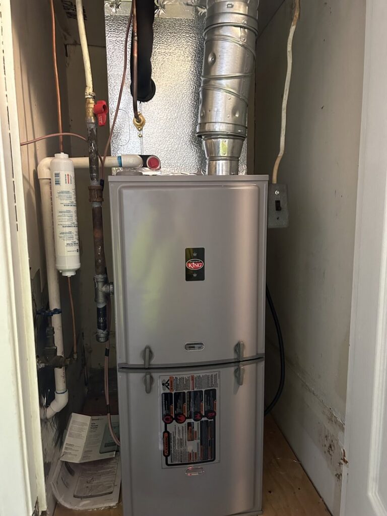An indoor King furnace and air handler unit professionally installed in a utility closet by Underwood Heating and Air Conditioning in Phenix City, AL