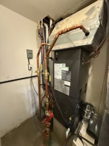 An indoor furnace and air handler unit with copper piping installed by Wes-Tech Services in Bloomington, IN.