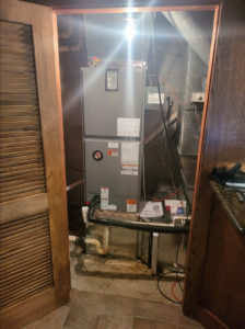 An indoor furnace and air handler unit installed by Zibi Construction in Mount Prospect, IL.