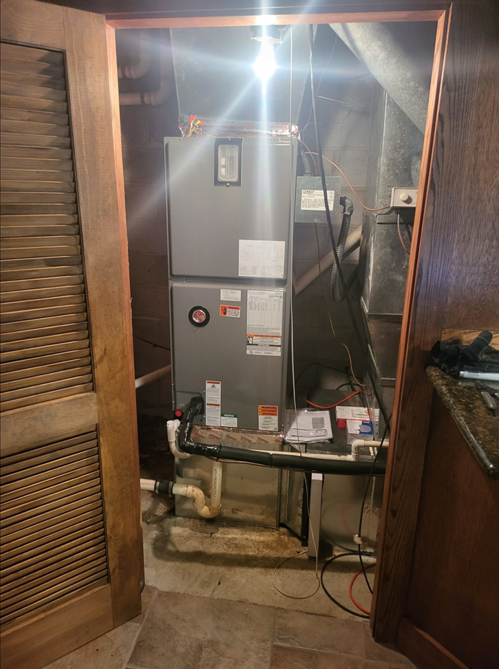An indoor furnace and air handler unit installed by Zibi Construction in Mount Prospect, IL.